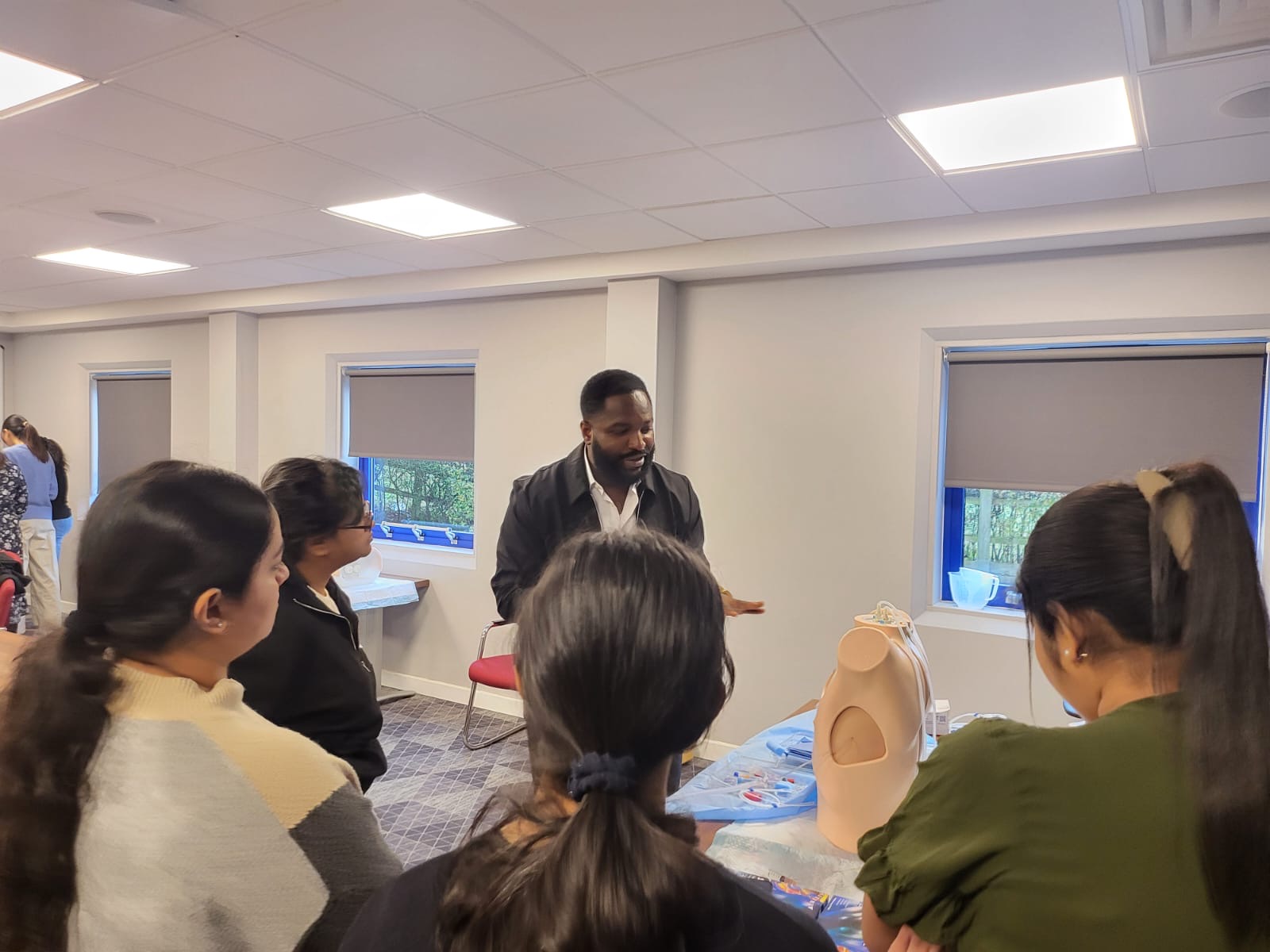 Dr. Joshua Igwe leading a hands-on clinical skills workshop